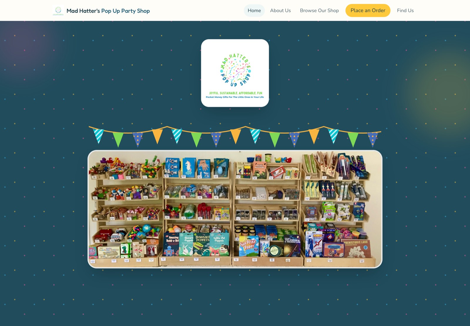 The Mad Hatter's Pop Up Party Shop homepage: a confetti logo and bunting above a photograph of the stall's shelves full of pocket-money toys.